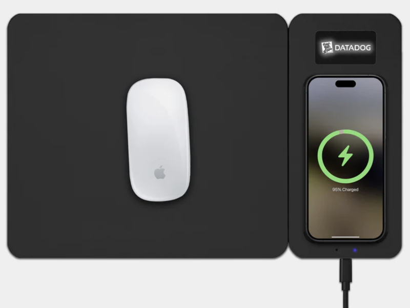 Wireless charging mouse pad in use with engraved LED logo